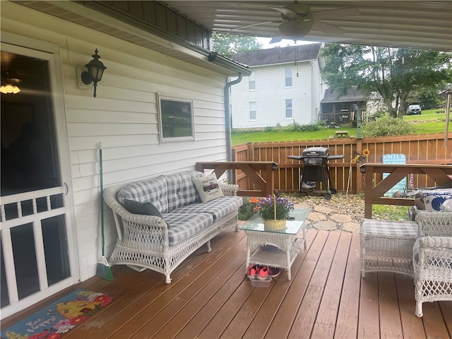 wooden terrace featuring ceiling fan and a grill