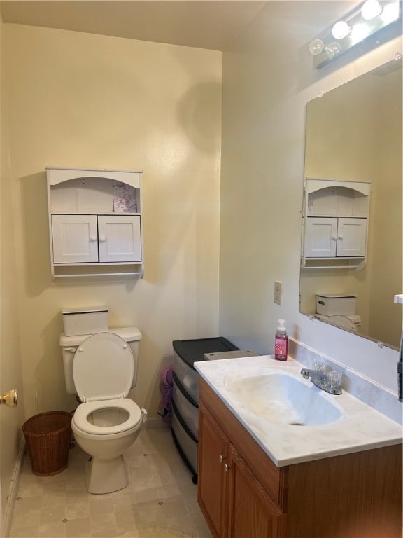 bathroom featuring vanity, tile patterned flooring, and toilet