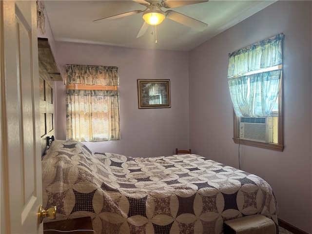 bedroom featuring cooling unit, multiple windows, and ceiling fan