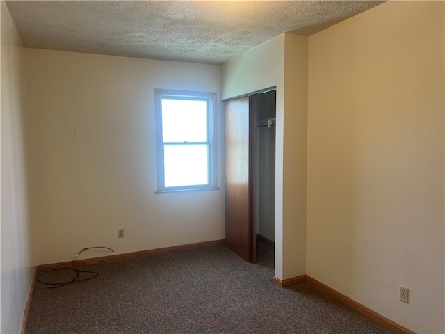 unfurnished bedroom with carpet and a textured ceiling