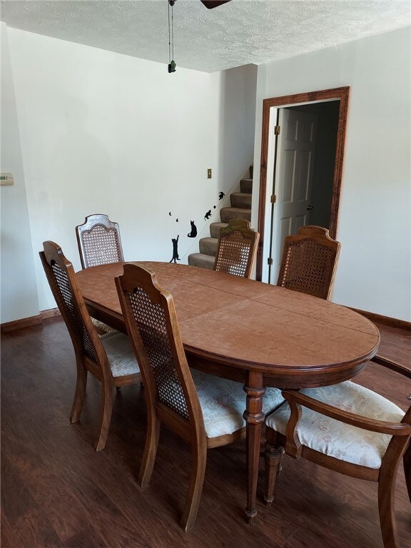 dining area featuring hardwood / wood-style floors and a textured ceiling