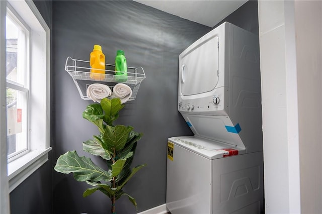 laundry area featuring stacked washer and clothes dryer