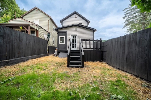 rear view of property featuring a wooden deck