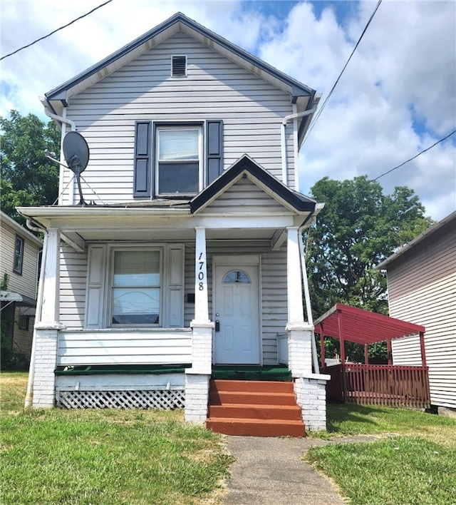 view of front facade with covered porch and a front yard