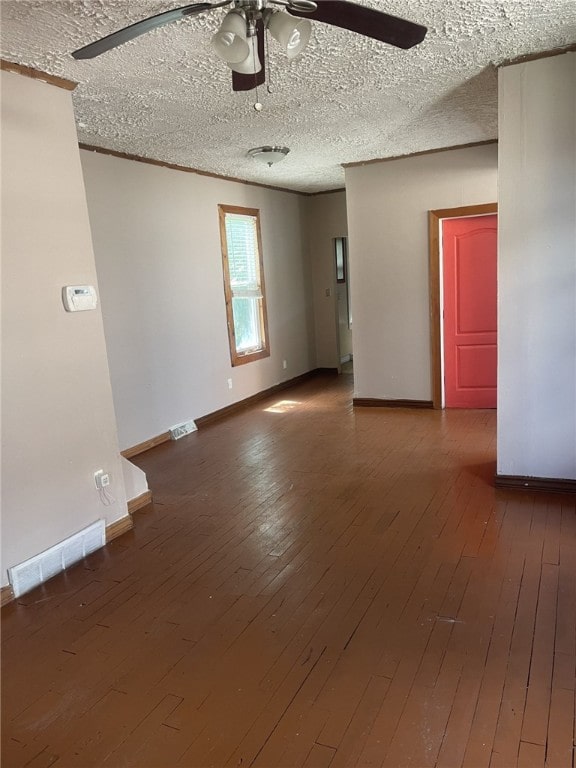 spare room featuring a textured ceiling, wood-type flooring, and ceiling fan