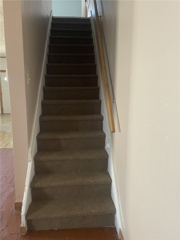 staircase with wood-type flooring