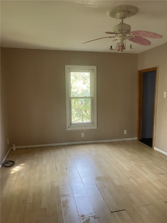 empty room featuring ceiling fan and light hardwood / wood-style floors