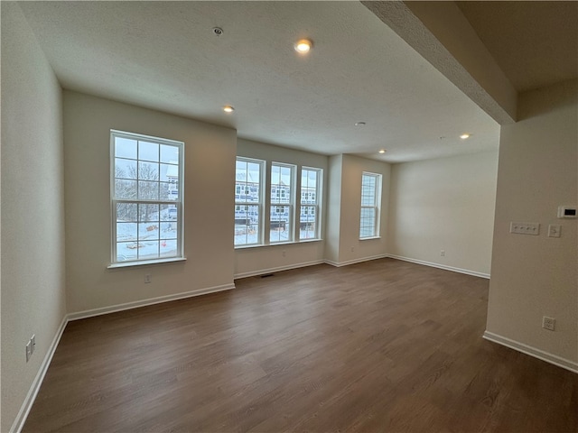 empty room featuring dark wood-type flooring