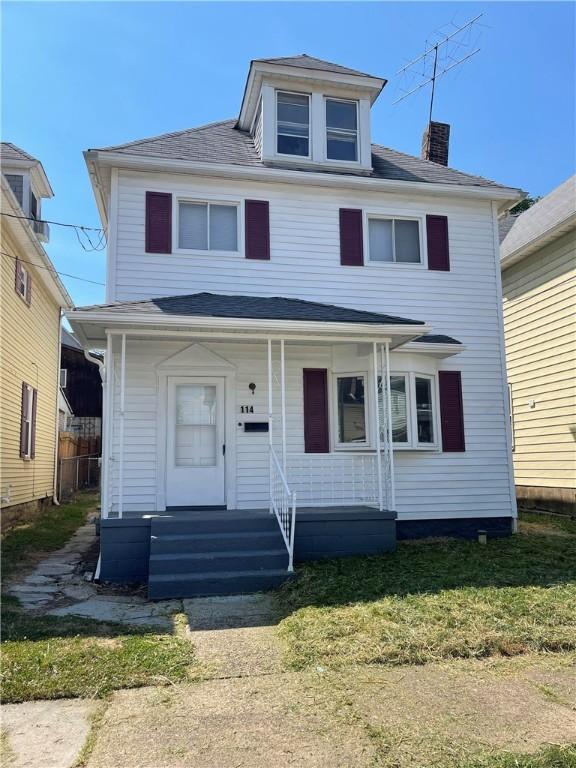 american foursquare style home featuring a chimney