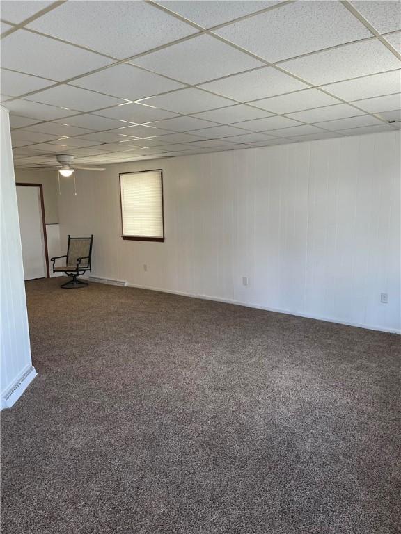 basement featuring a drop ceiling and carpet flooring