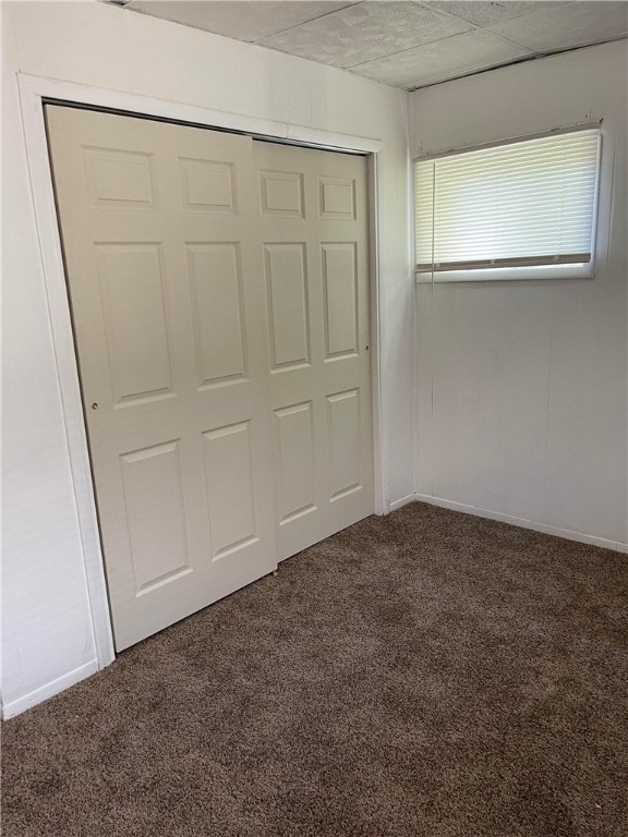 unfurnished bedroom with carpet and a closet