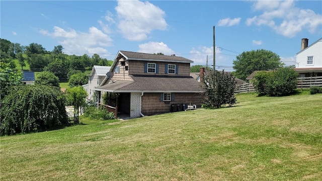 back of property featuring a lawn