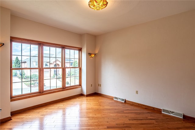 spare room with light hardwood / wood-style floors