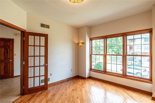 unfurnished room with light hardwood / wood-style flooring