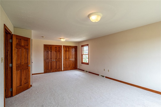 spare room with light colored carpet