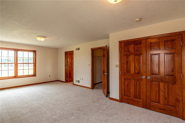 unfurnished bedroom with light colored carpet