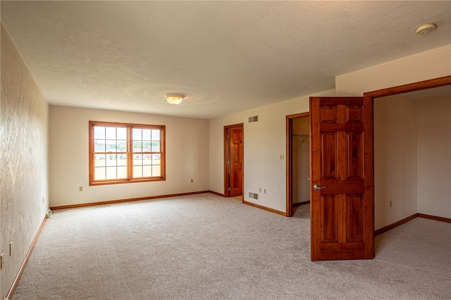 empty room with light colored carpet