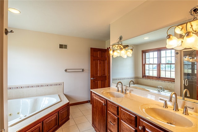 bathroom with tile patterned flooring, tiled bath, and dual bowl vanity