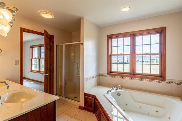 bathroom with vanity, shower with separate bathtub, and tile patterned flooring