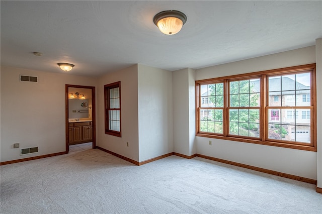 unfurnished room with light colored carpet