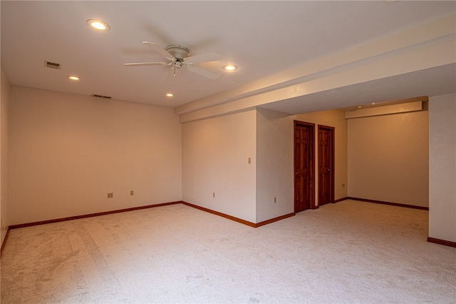 carpeted spare room featuring ceiling fan