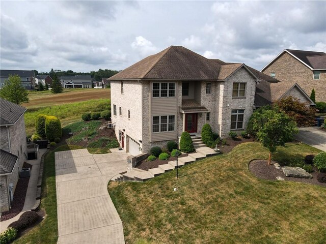 view of front of property featuring a garage and a front yard