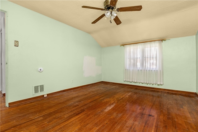 unfurnished room featuring ceiling fan, lofted ceiling, a textured ceiling, and hardwood / wood-style flooring