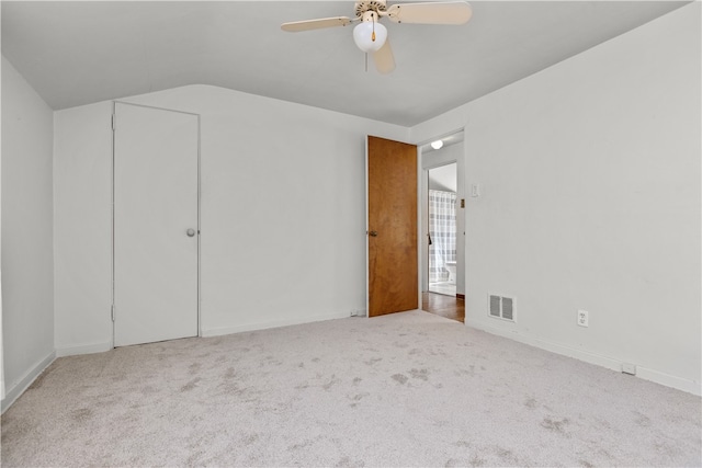 unfurnished bedroom with carpet, vaulted ceiling, and ceiling fan