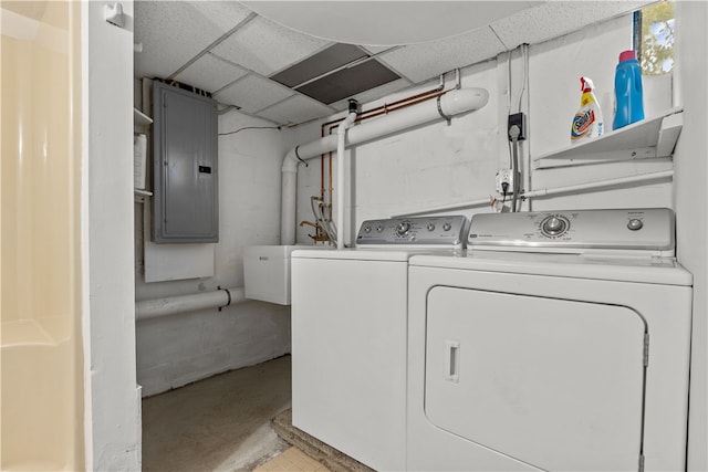 laundry area with sink, washing machine and dryer, and electric panel