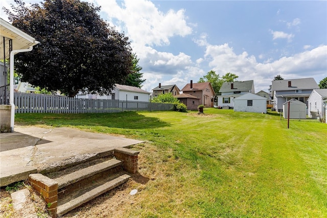 view of yard featuring a storage unit and a patio area