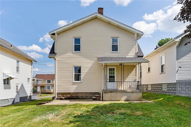 back of property featuring a porch and a lawn