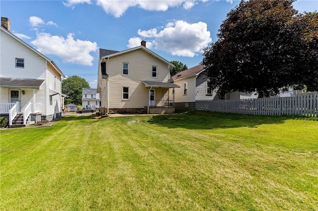 back of property with a lawn