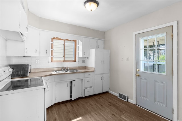 kitchen featuring white cabinetry, white range with electric cooktop, dark hardwood / wood-style floors, decorative backsplash, and sink