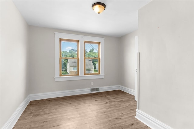 spare room with light hardwood / wood-style flooring