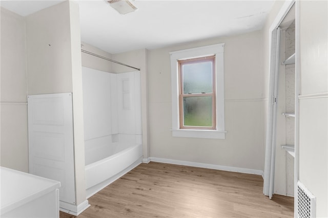 bathroom featuring hardwood / wood-style flooring and shower / bathing tub combination