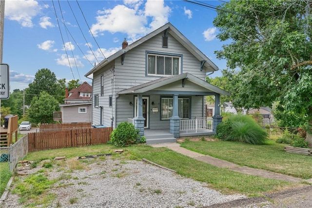 bungalow-style home featuring a front lawn and covered porch