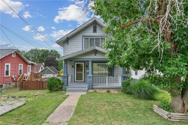 bungalow-style home featuring a porch and a front yard