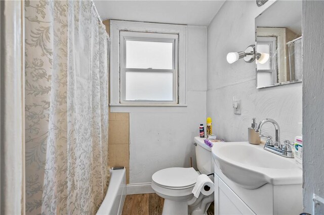 full bathroom with vanity, shower / bath combo with shower curtain, wood-type flooring, and toilet