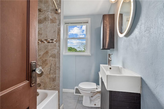 full bathroom featuring vanity, tiled shower / bath combo, toilet, and tile patterned flooring