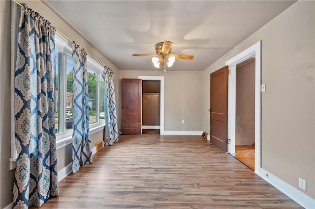 spare room featuring light hardwood / wood-style flooring and ceiling fan