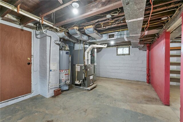 basement featuring water heater and heating unit