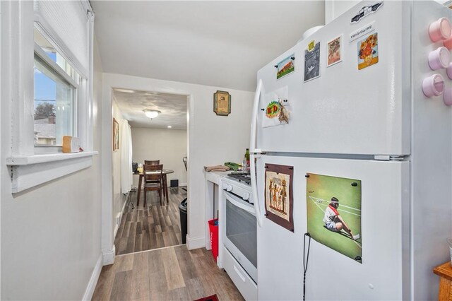 kitchen featuring wood-type flooring and white appliances