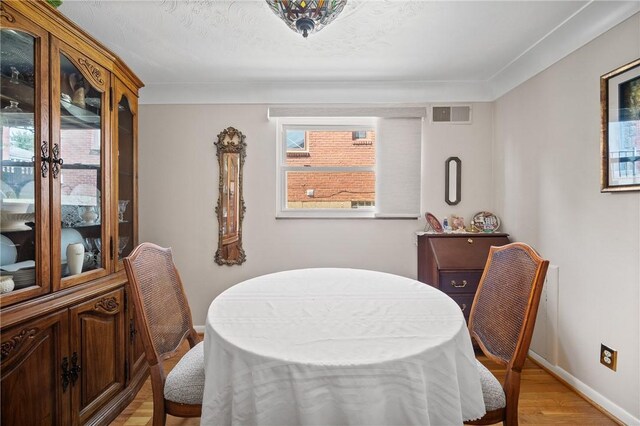 dining area featuring light wood-type flooring and a wealth of natural light