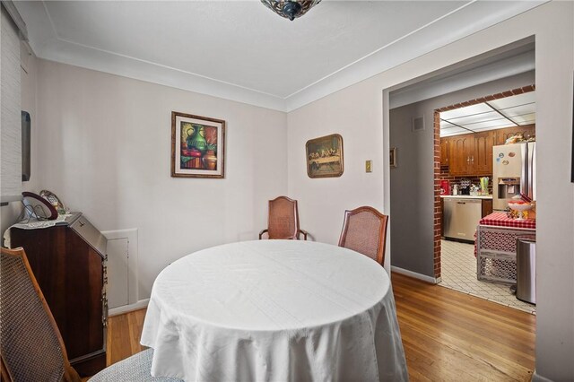 dining space featuring light wood-type flooring