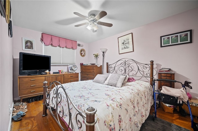 bedroom with ceiling fan and dark wood-type flooring