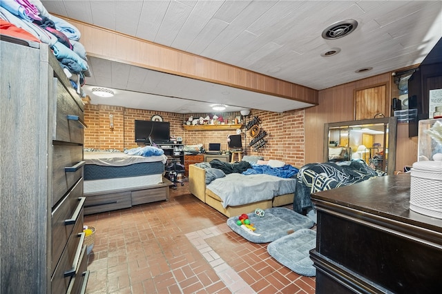 bedroom featuring wood walls and brick wall