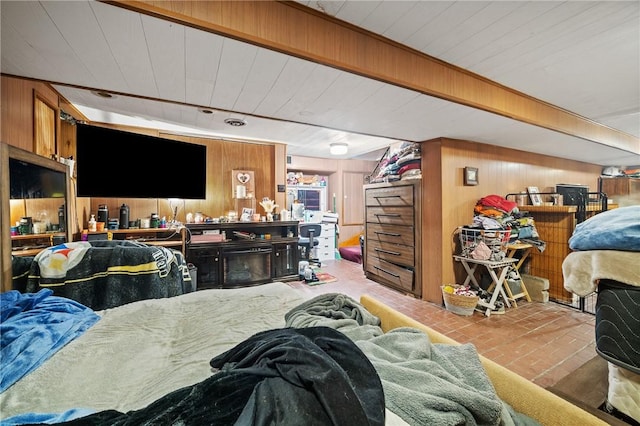 bedroom with wooden walls and beamed ceiling