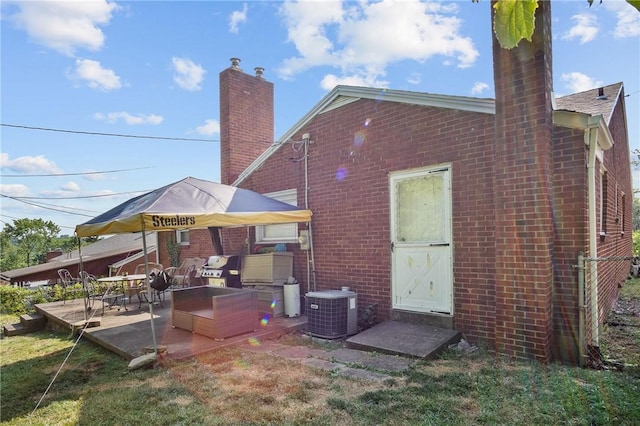 back of property featuring central AC and a patio area