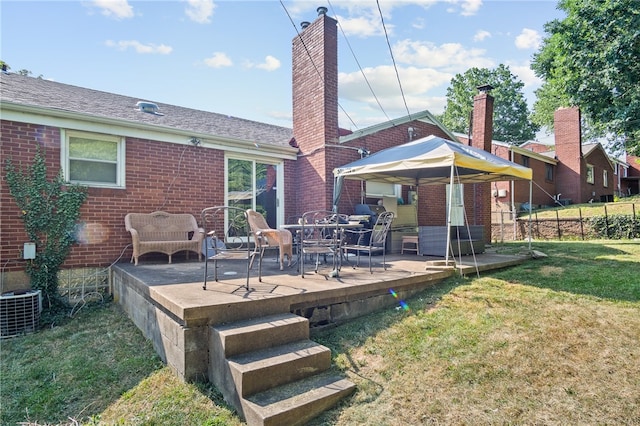 back of house with a wooden deck and a lawn