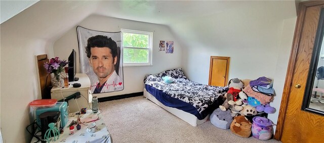 bedroom featuring carpet floors and vaulted ceiling